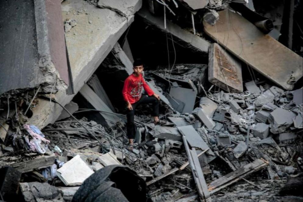 Un ragazzo palestinese tra le macerie di un edificio crollato dopo un attacco israeliano a Gaza - Ansa