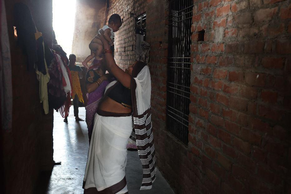 An ASHA worker plays with a child during a home visit in rural Uttar Pradesh. Each ASHA is responsible for the health of 1,000 to 2,500 people in her community - Sejal (Khabar Lahariya)